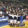 The team yelling (something) together before tip-off